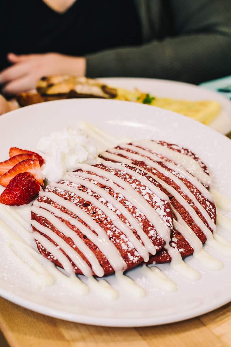 stack of red velvet pancakes with a glaze