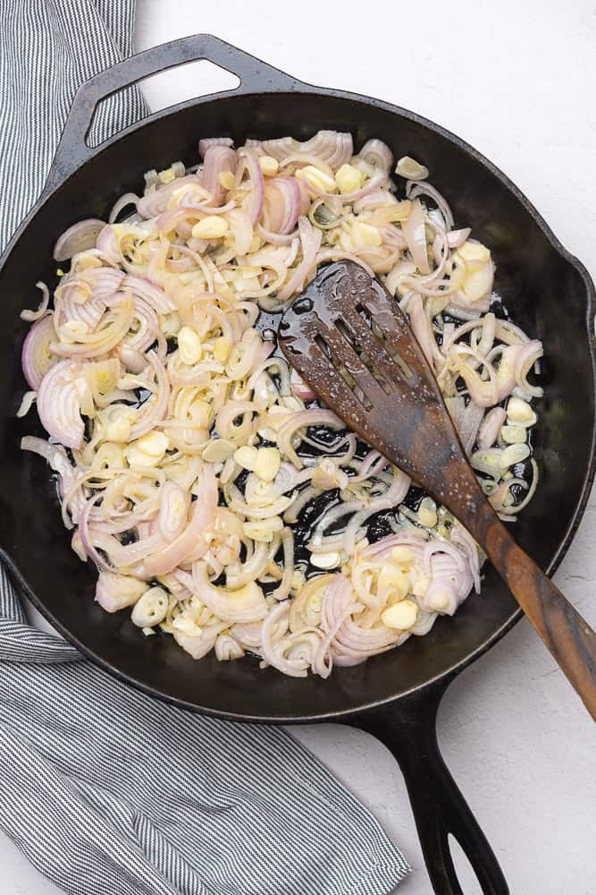 shallots and garlic in olive oil in a cast iron skillet