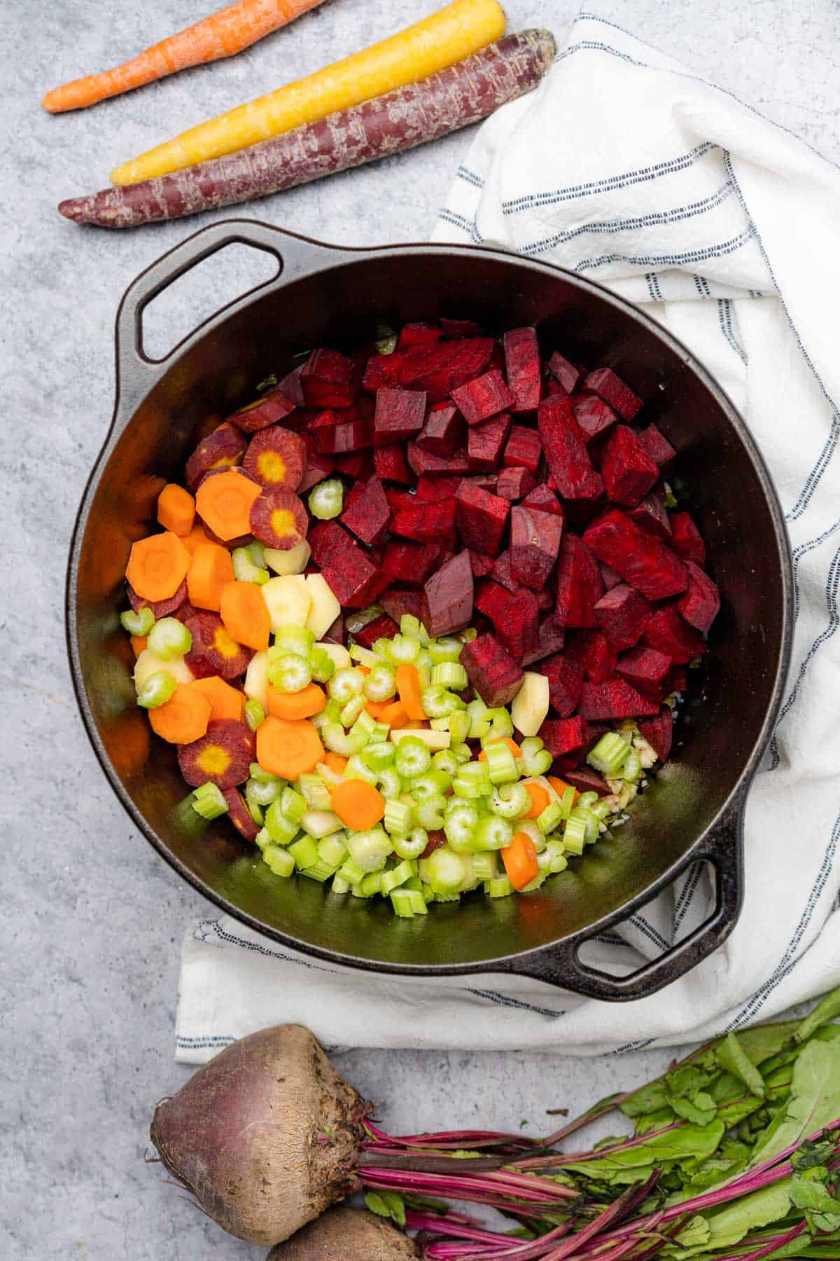 beetroot with celery and carrots in a cast iron dutch oven