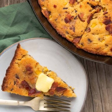 brown butter cornbread with bacon with a pat of butter and a cast iron skillet near by