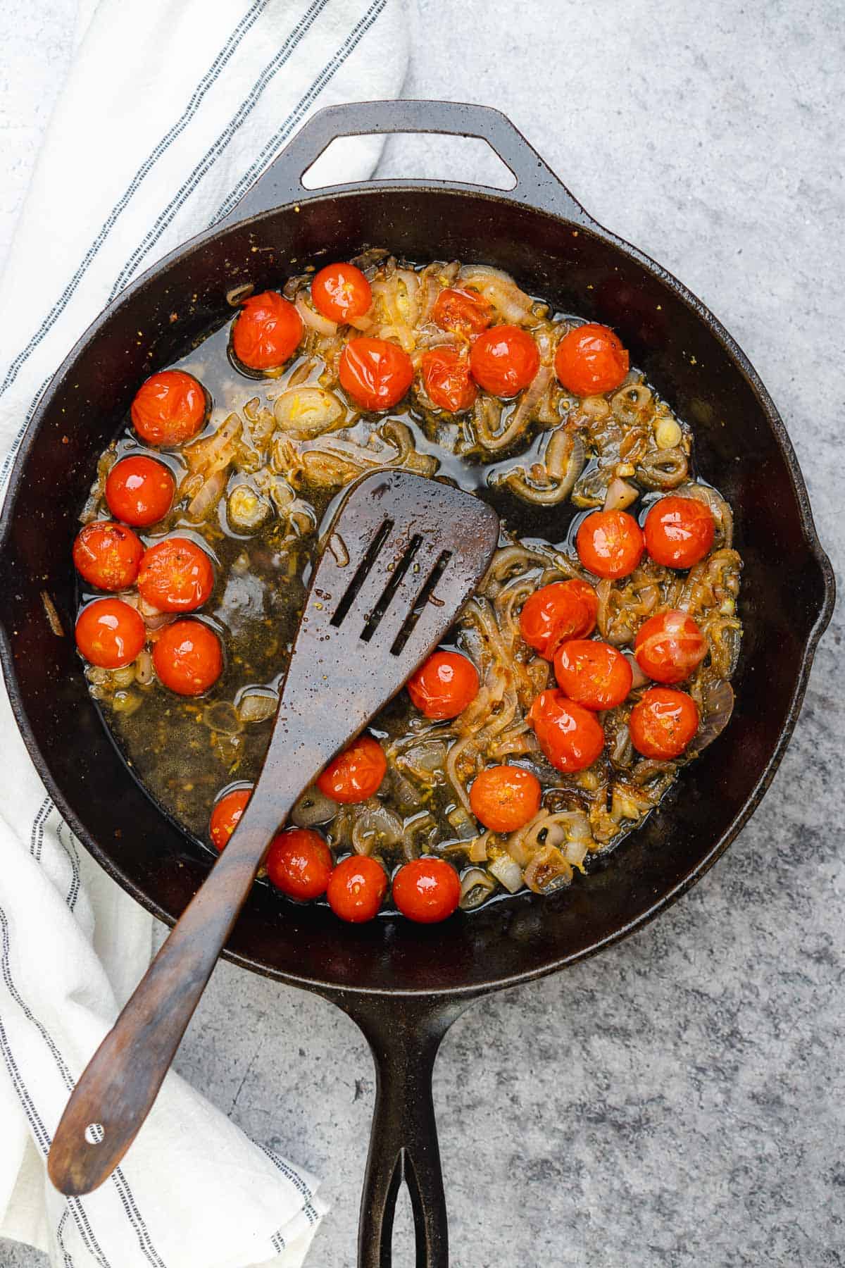 tomatoes with shallots in a cast iron skillet