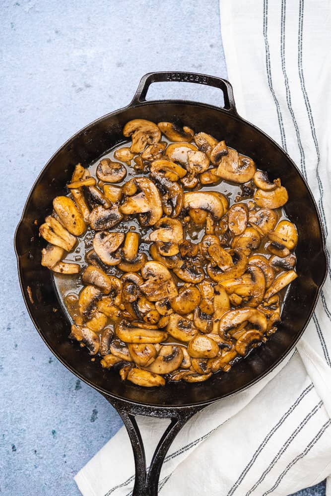 cooked mushrooms in a cast iron skillet