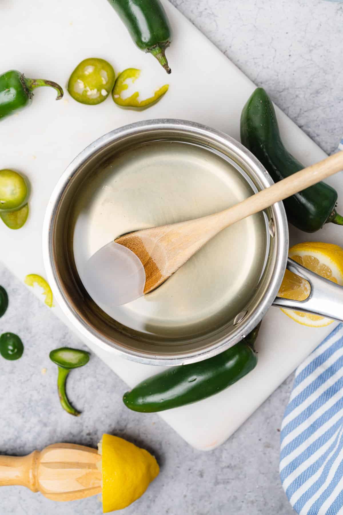 stirring allulose and water together to create jalapeno simple syrup