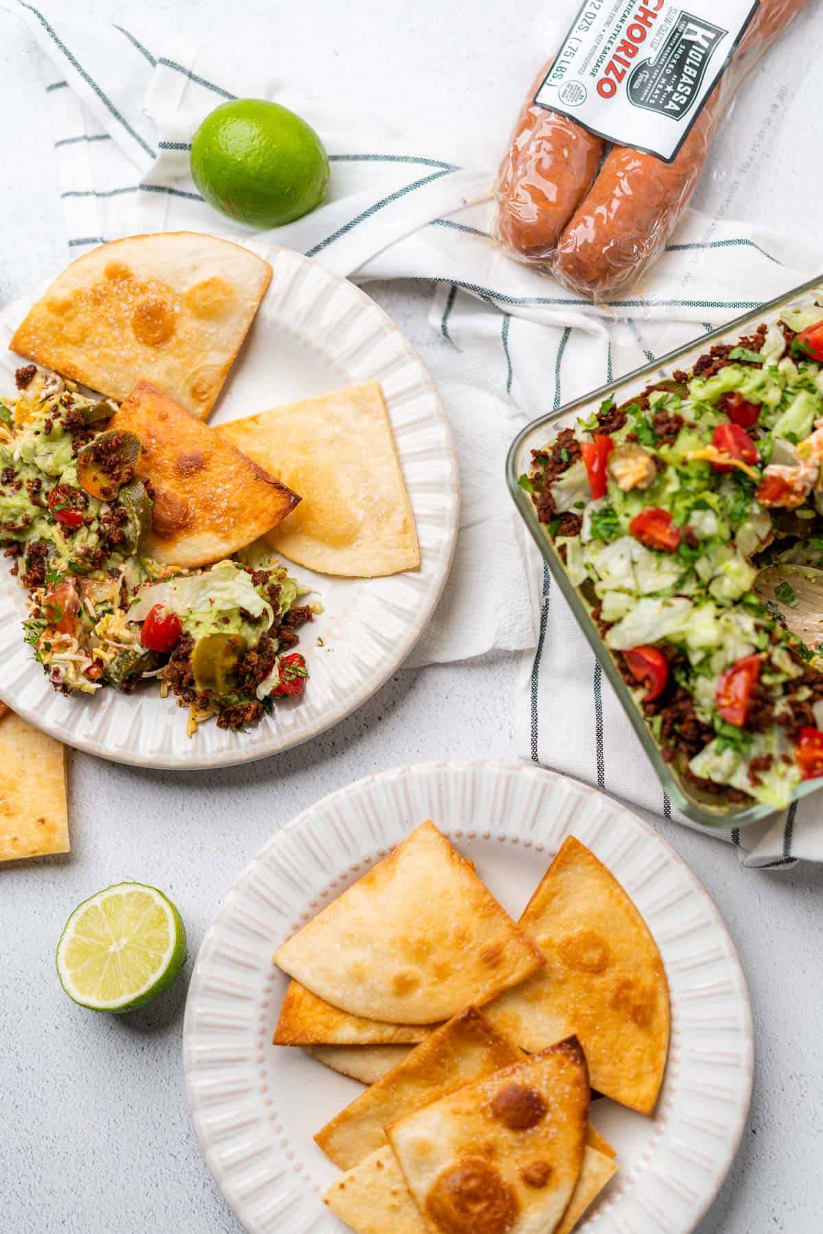 keto 7 layer dip with chorizo flat lay with homemade low carb tortilla chips