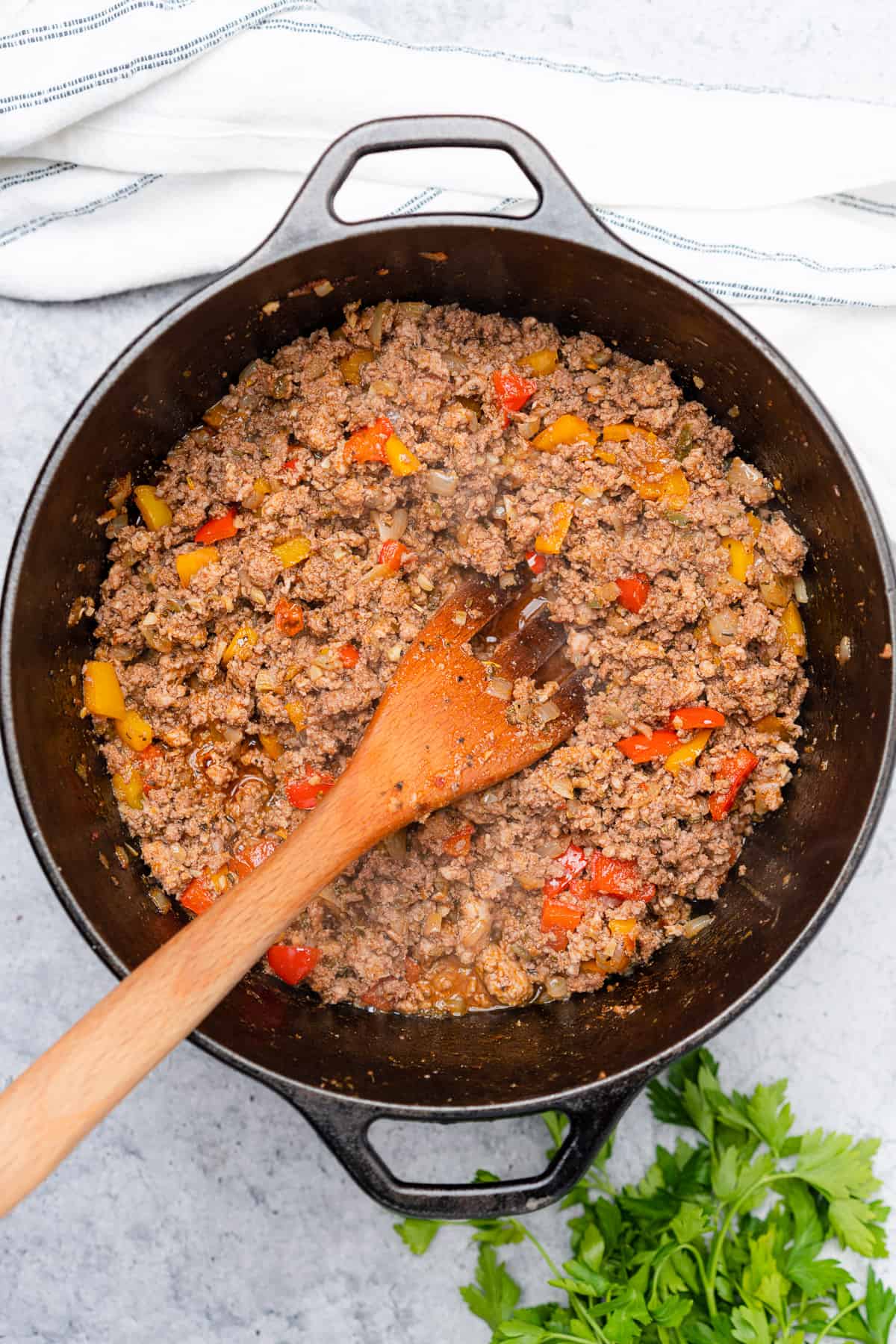 ground beef and pork browned in a cast iron dutch oven with bell peppers 