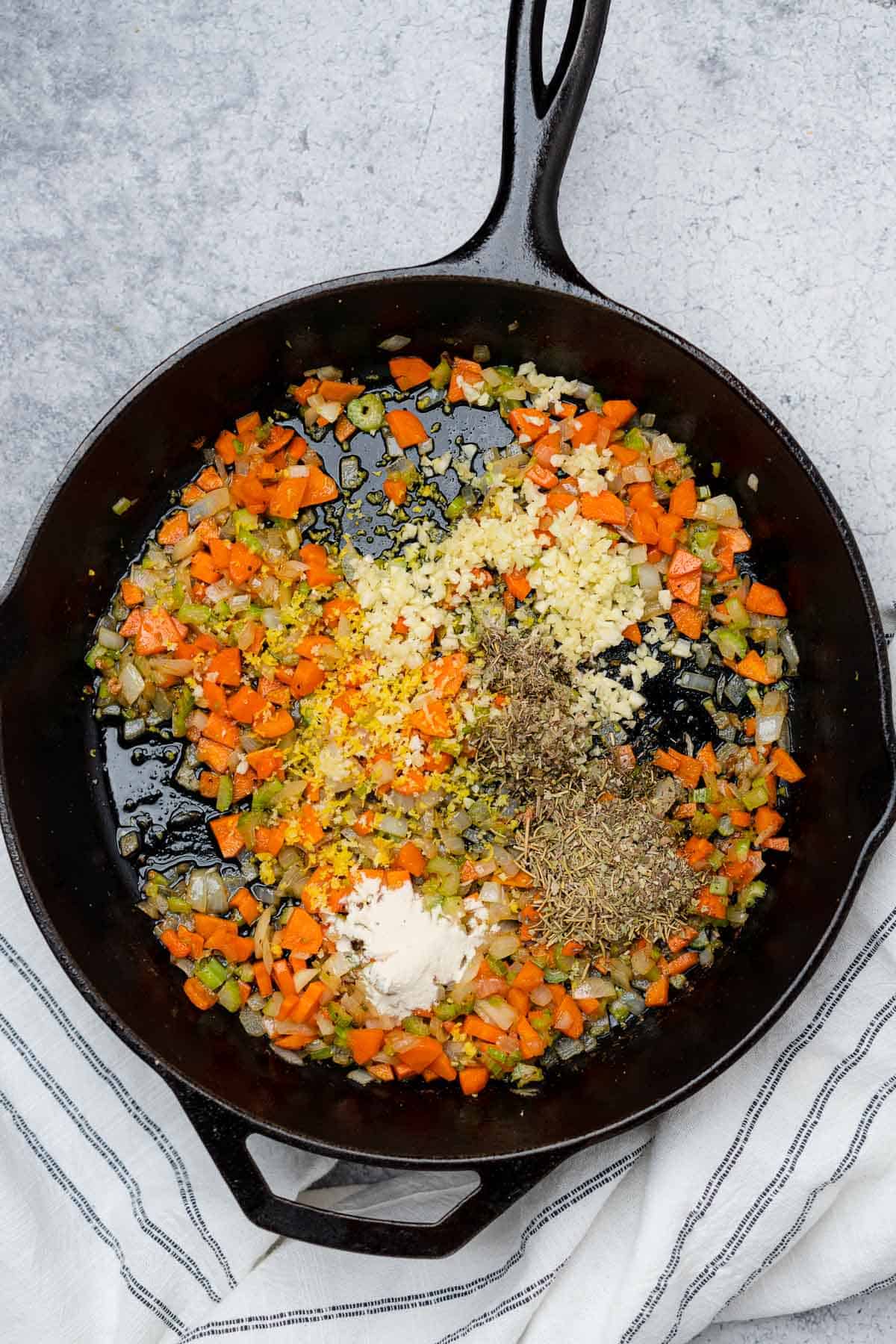 sauteed onions carrots and celery in a cast iron skillet with fresh garlic black pepper italian seasoning lemon zest and xanthan gum