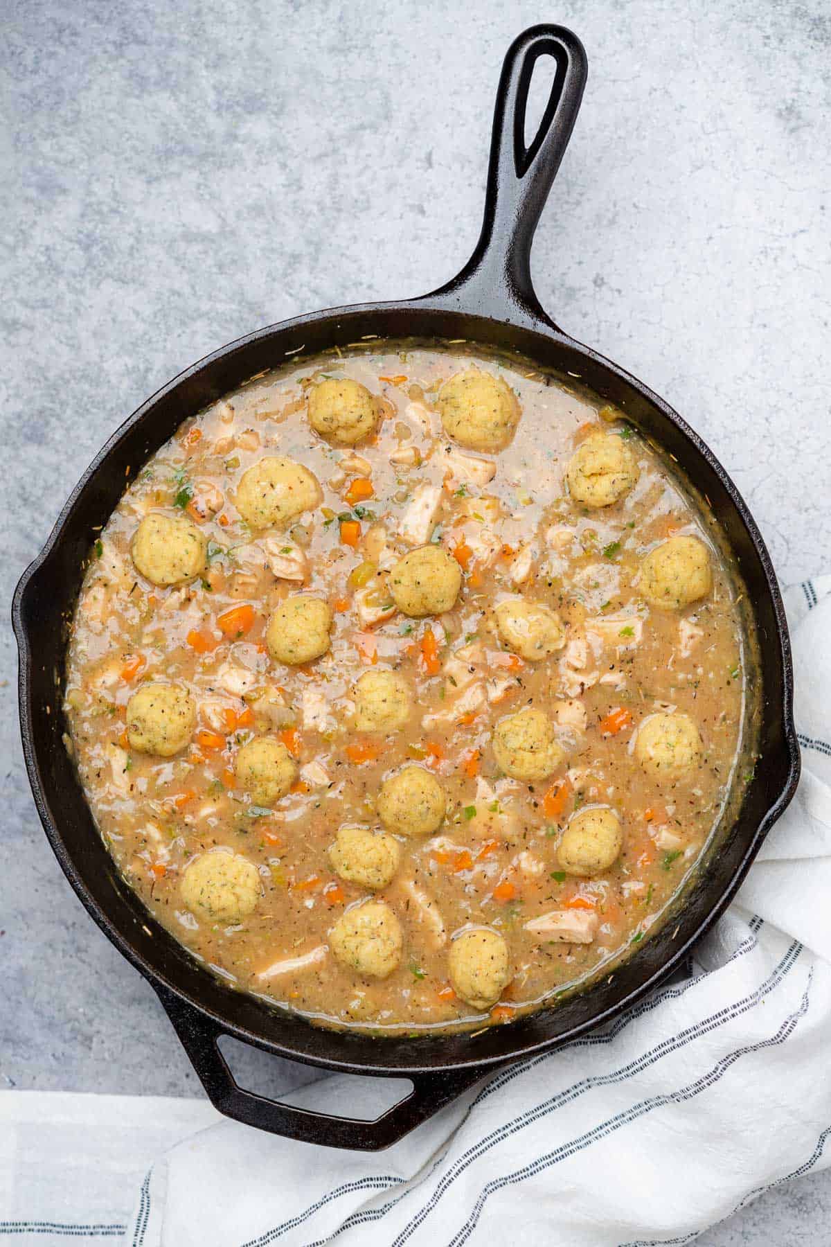 chicken with fresh dumplings in a cast iron skillet 