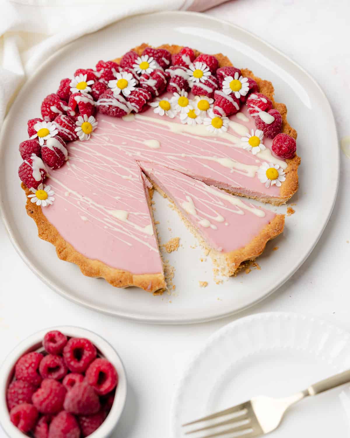 white chocolate raspberry tart with fresh raspberries and chamomile