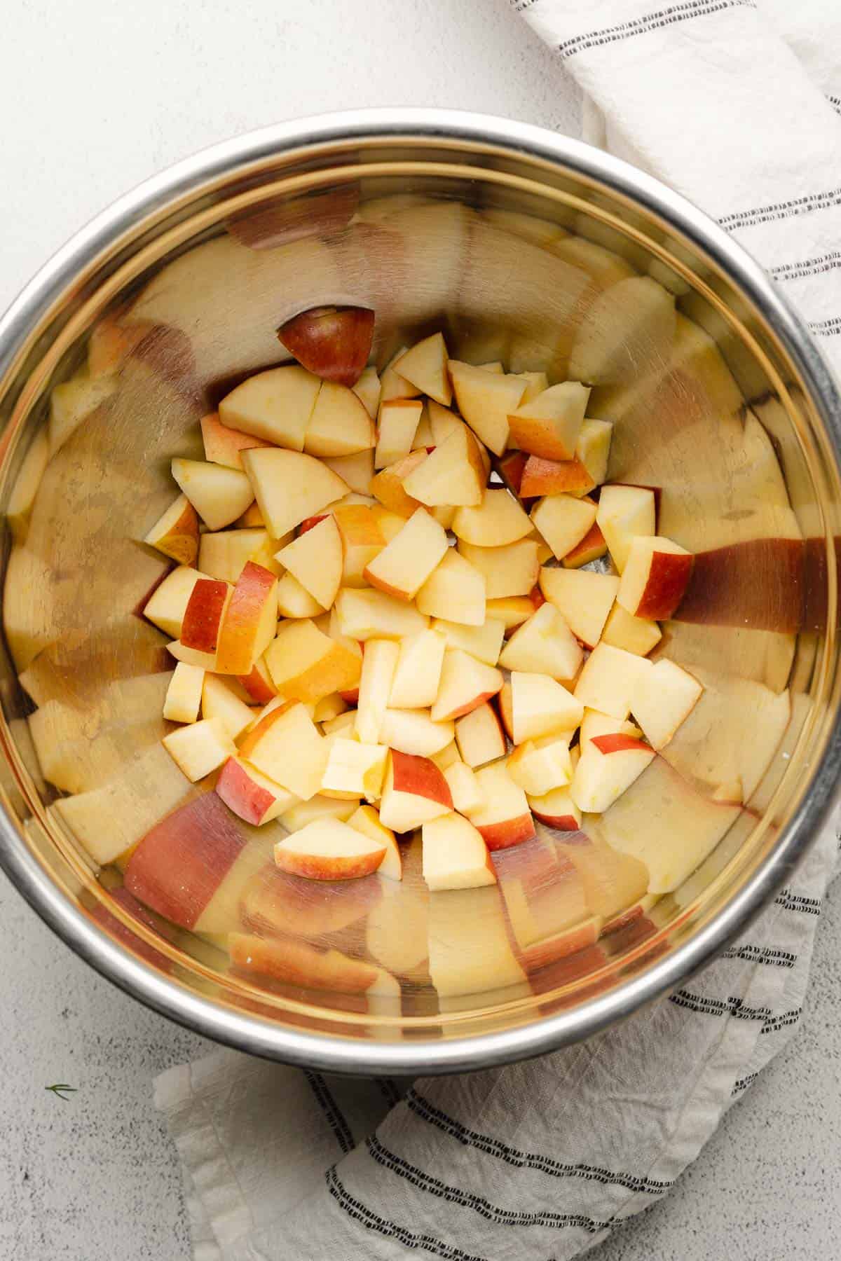 apples cut up in a metal bowl