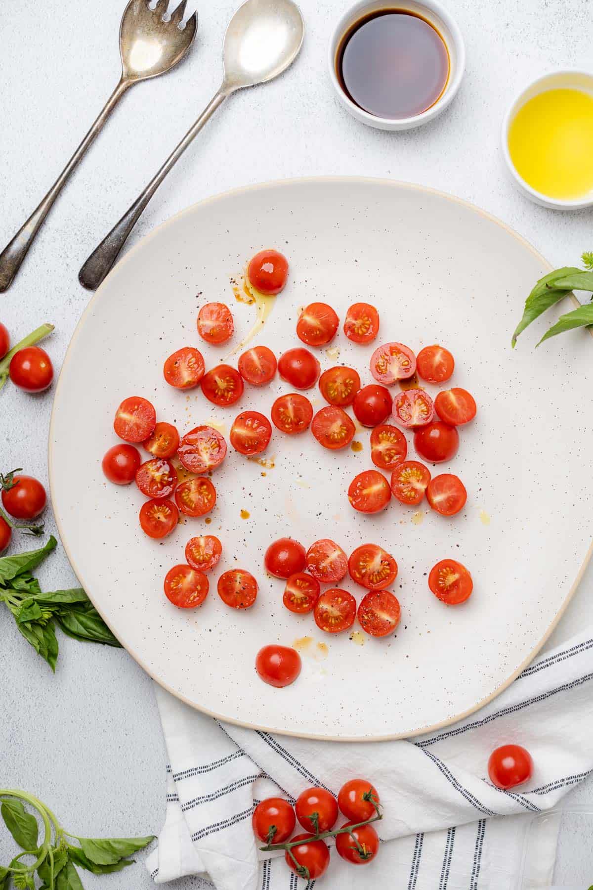 tomatoes on a ceramic charging plate for a salad 