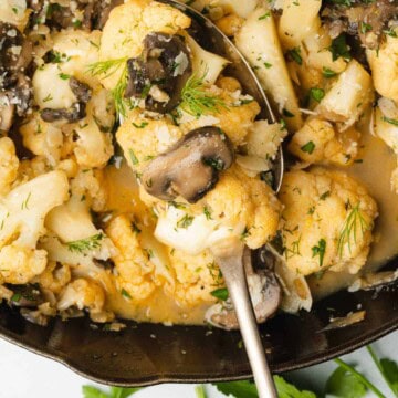 spoonful of cauliflower mushroom side in a cast iron skillet