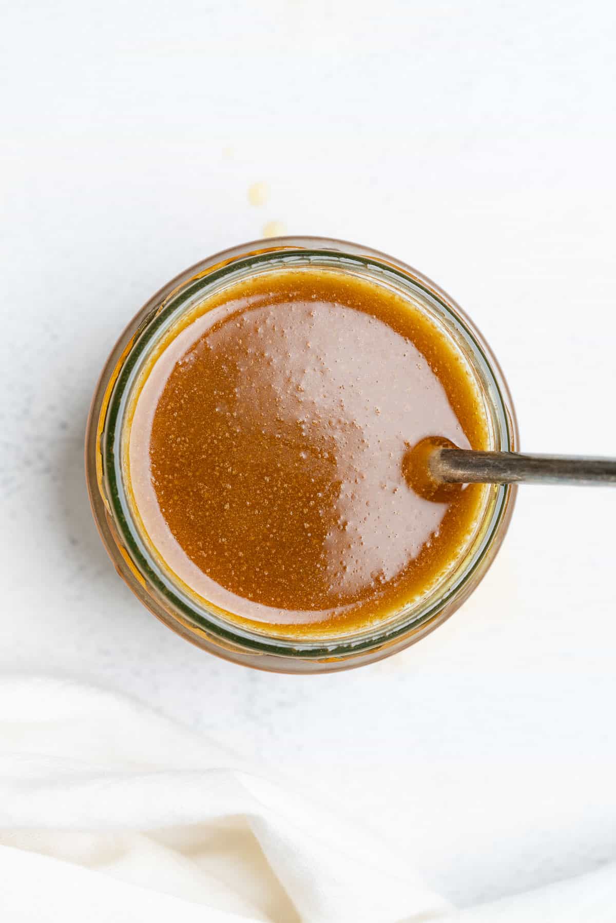 creamy balsamic dressing in a jar with a spoon