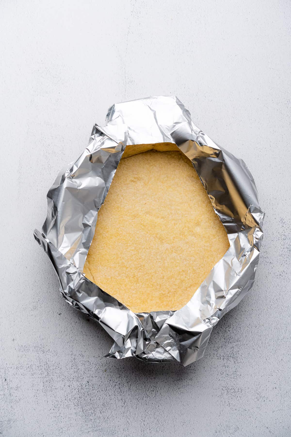 edges of pie crust covered by aluminum foil 