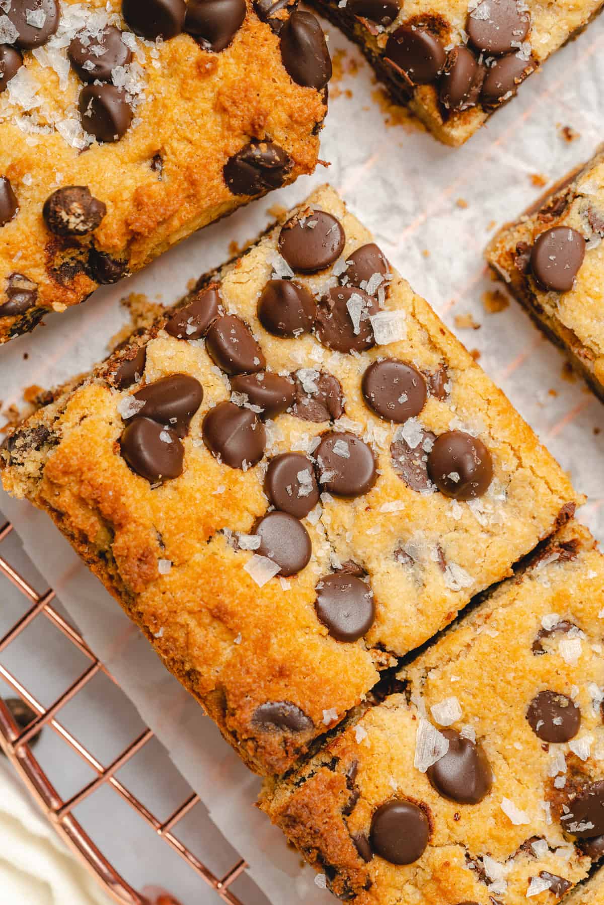 closeup shot of keto chocolate chip cookie bars with salt flakes