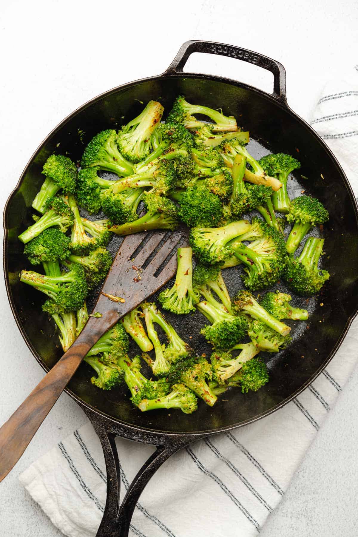 broccoli cooking in a cast iron skillet