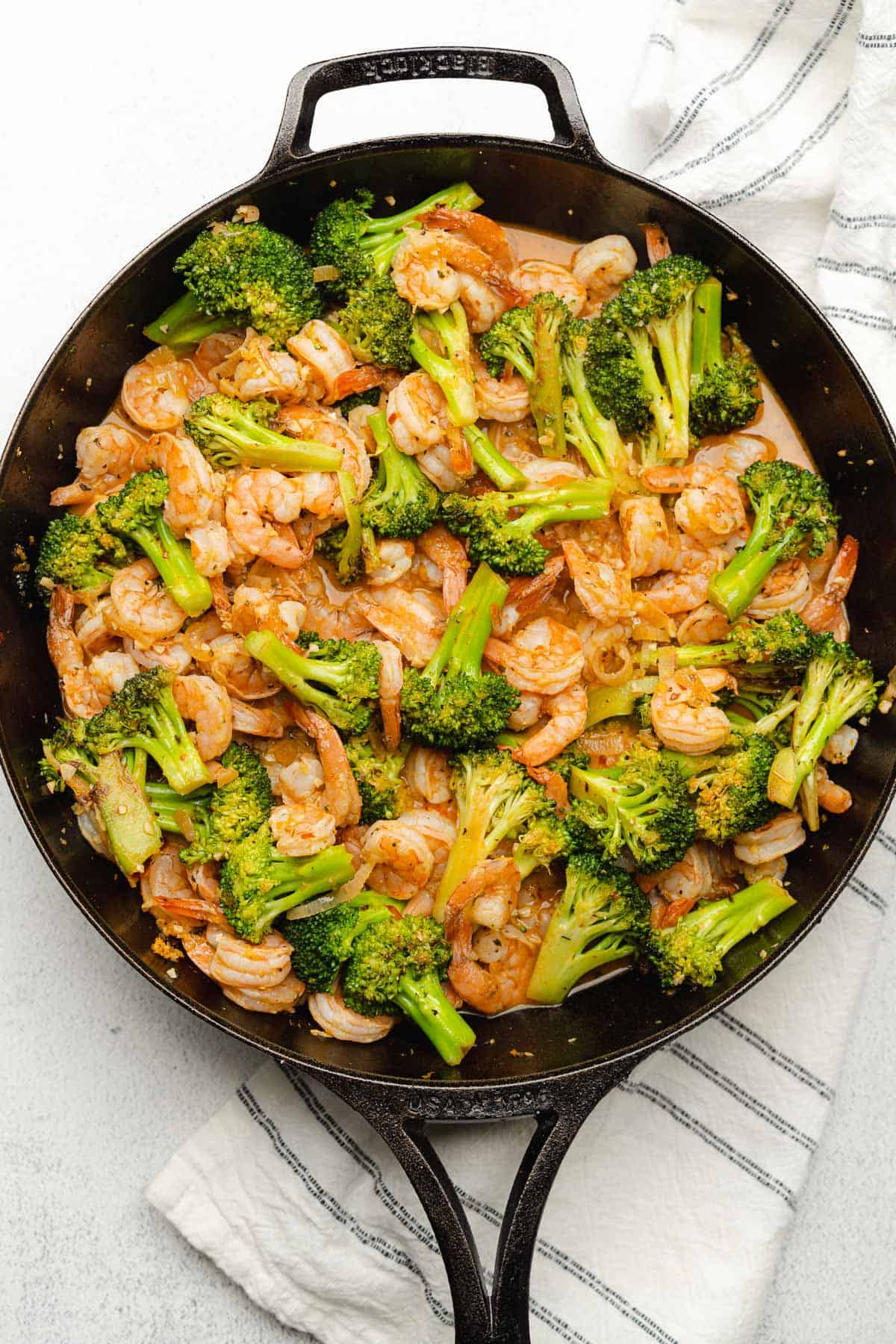 broccoli and shrimp in a cast iron skillet