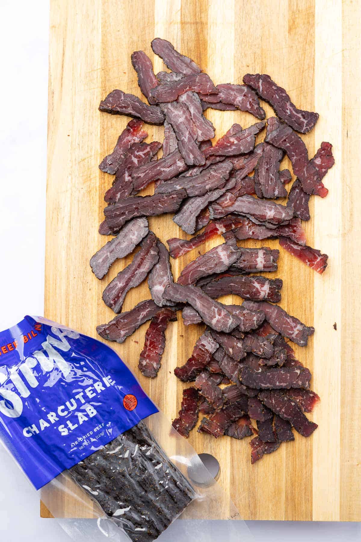 stryve beef biltong cut into thin strips on a cutting board
