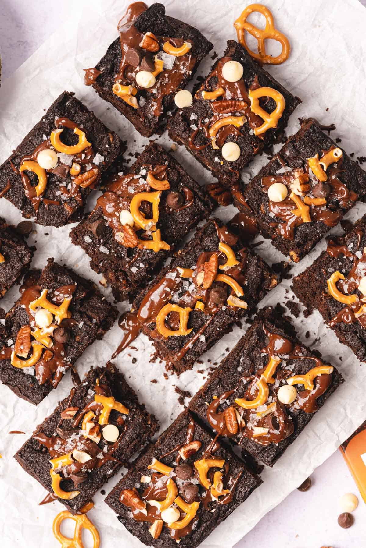 flat lay of dark cocoa kitchen sink brownies with pretzels and chocolate chips 