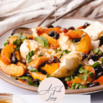 baked nectarines and cherries with burrata and a honey dripper drizzling over the salad