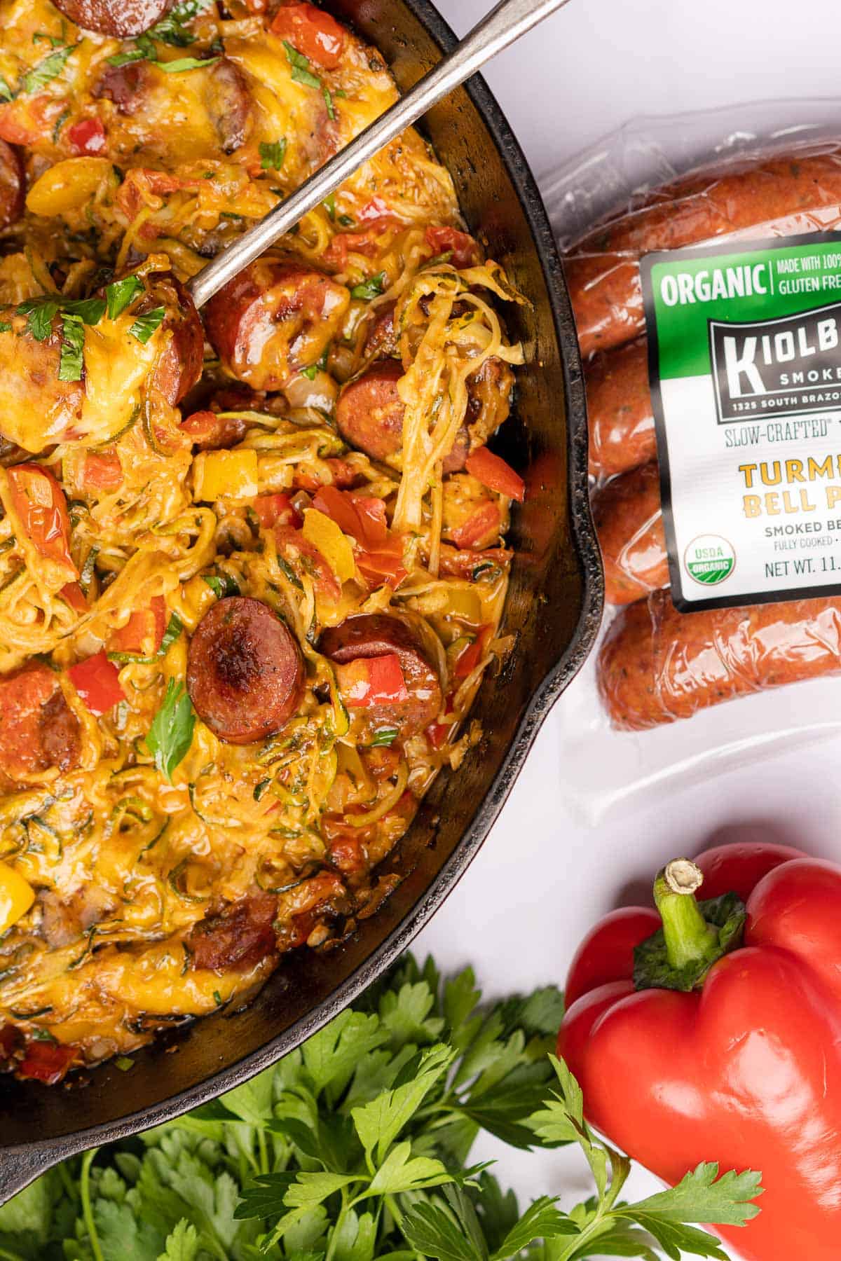 baked zucchini noodles casserole with smoked sausage and a package of kiolbassa smoked meats sausage