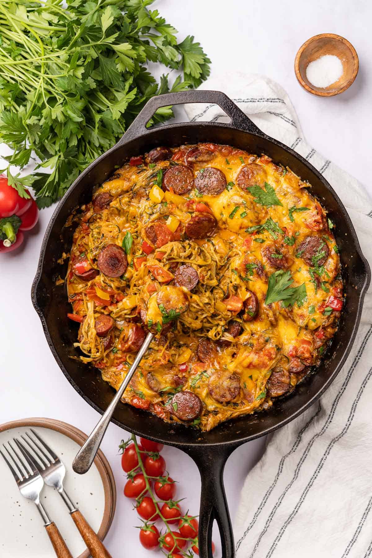complete casserole dish with smoked sausage, cheese, bell peppers and parsley