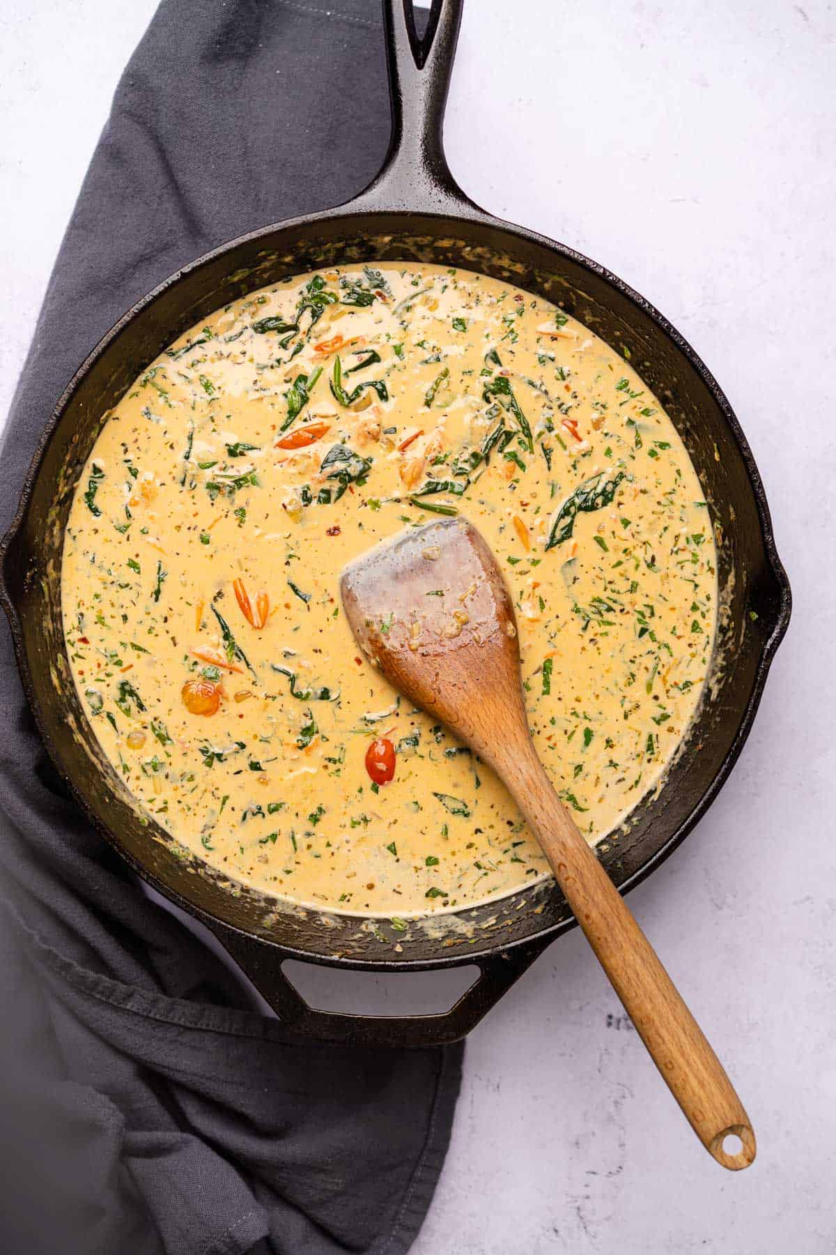 creamy sauce with herbs spinach and tomatoes