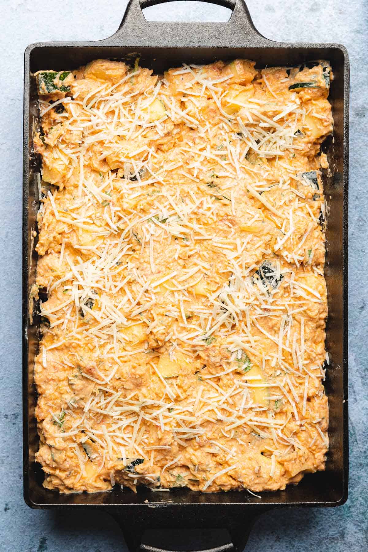 cheese zucchini mixture on the bottom of a casserole dish