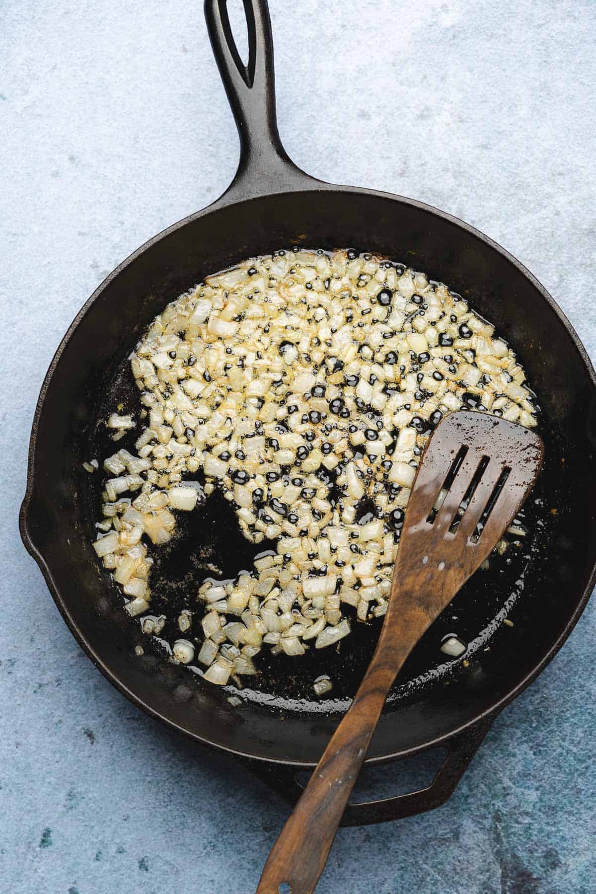 cooking onions in a cast iron skillet with butter