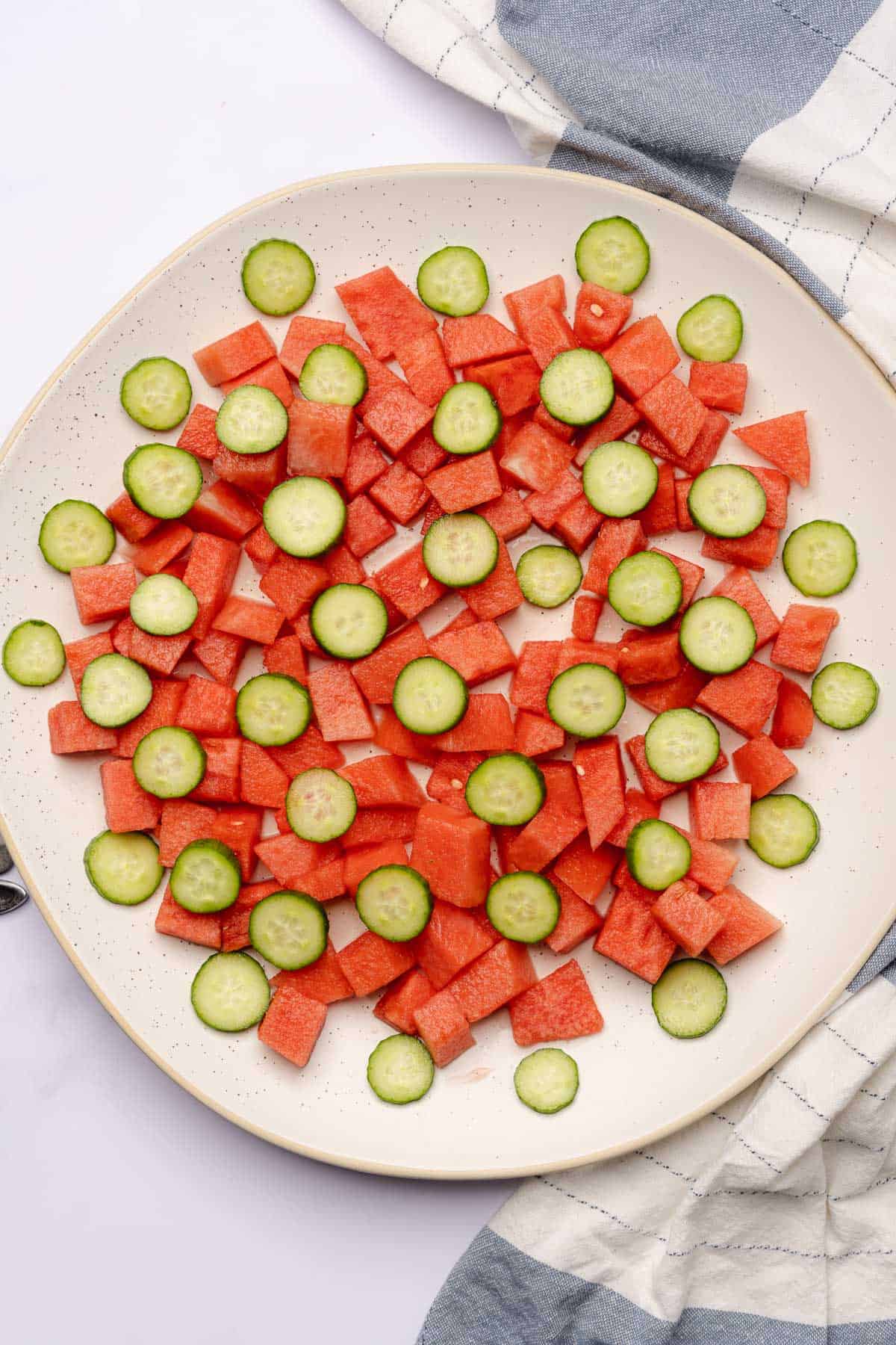 watermelon and cucumber slices on a large serving plate