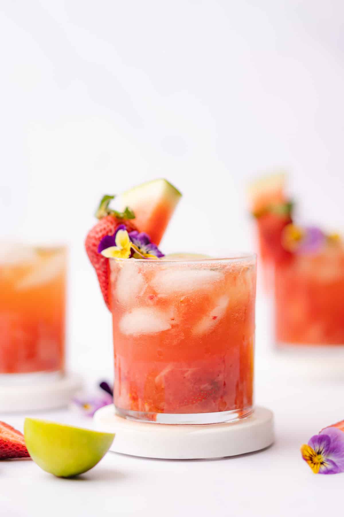 watermelon wine spritzer with edible flowers and strawberries