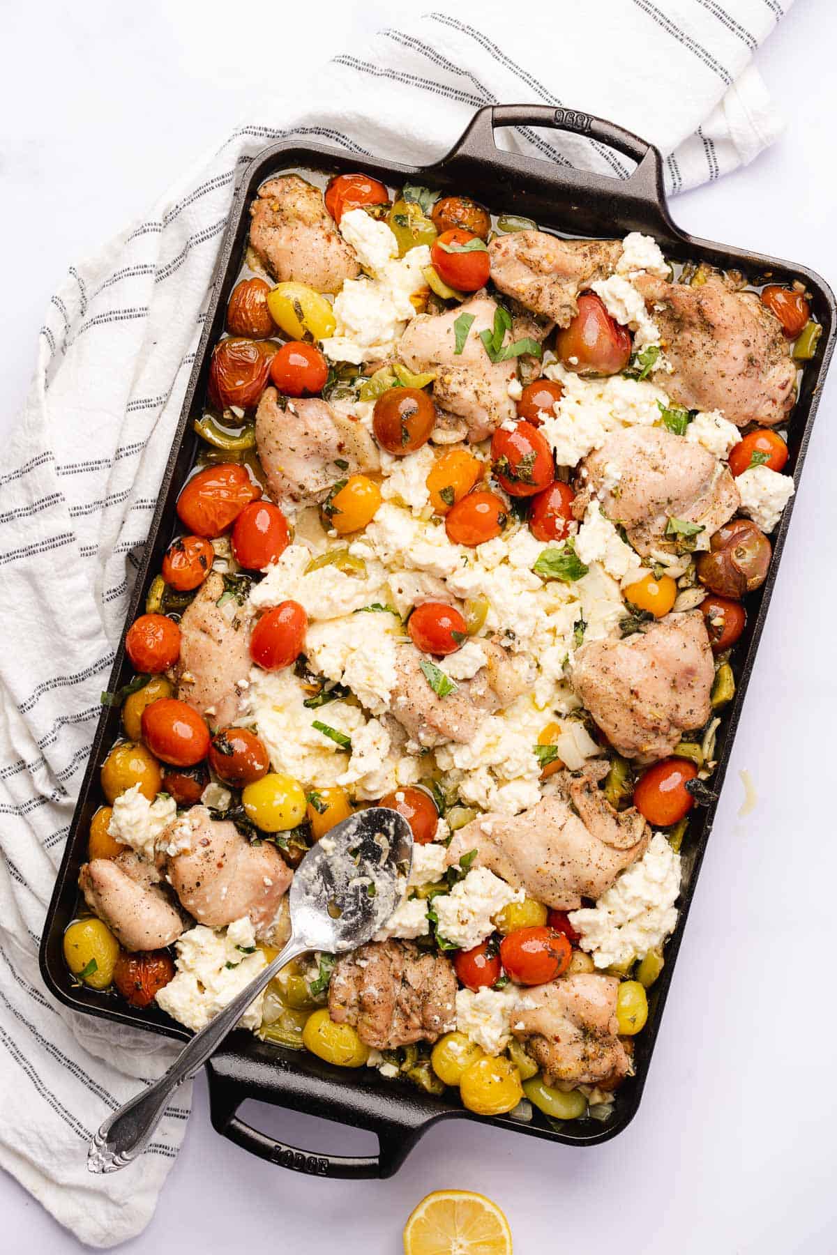 baked feta cheese with chicken thighs, tomatoes, and bell peppers 