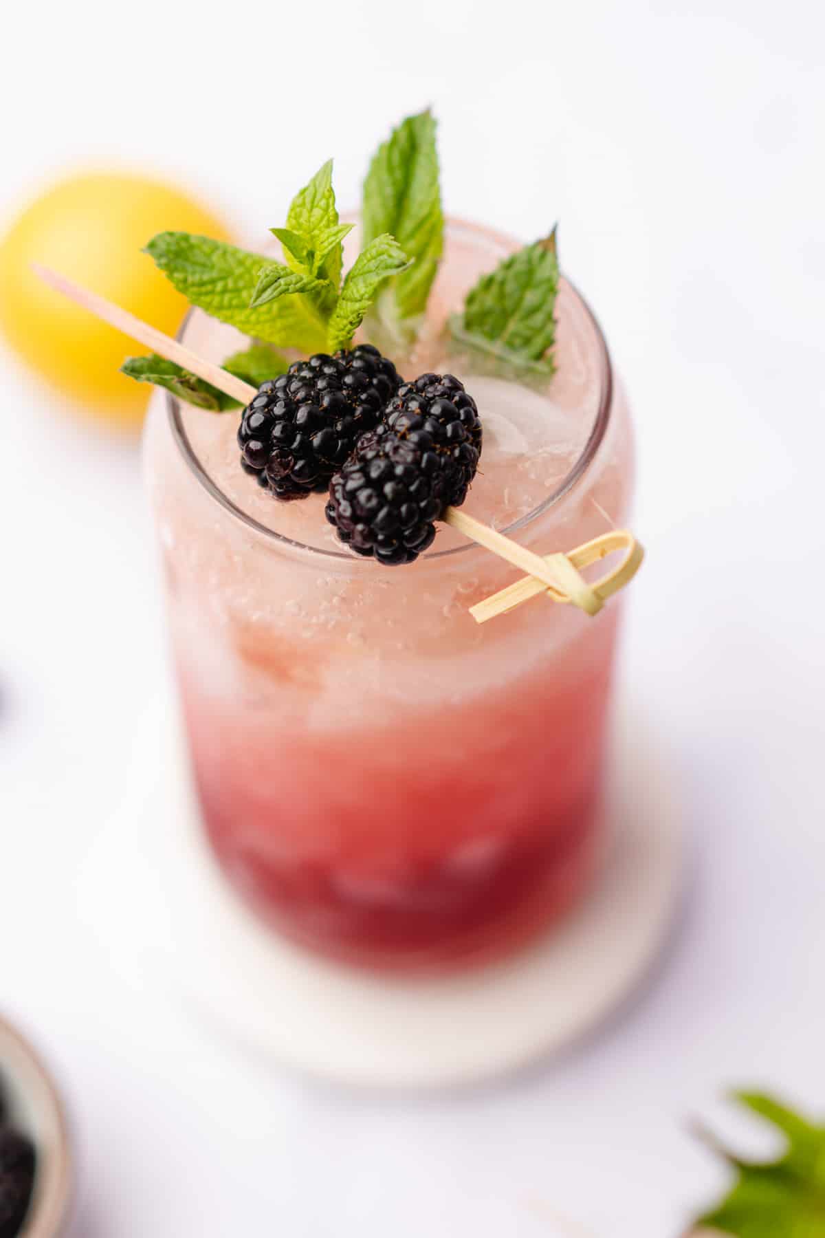 gorgeous keto blackberry bourbon bramble with fresh mint and lemon