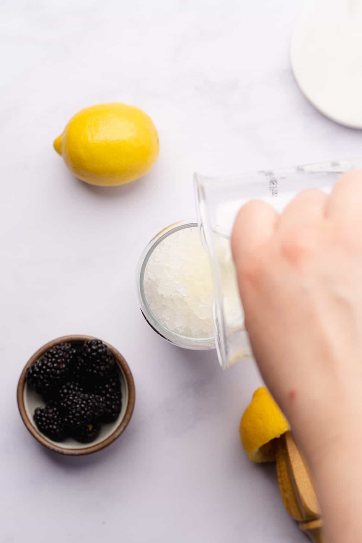 pouring lemon juice into a glass 