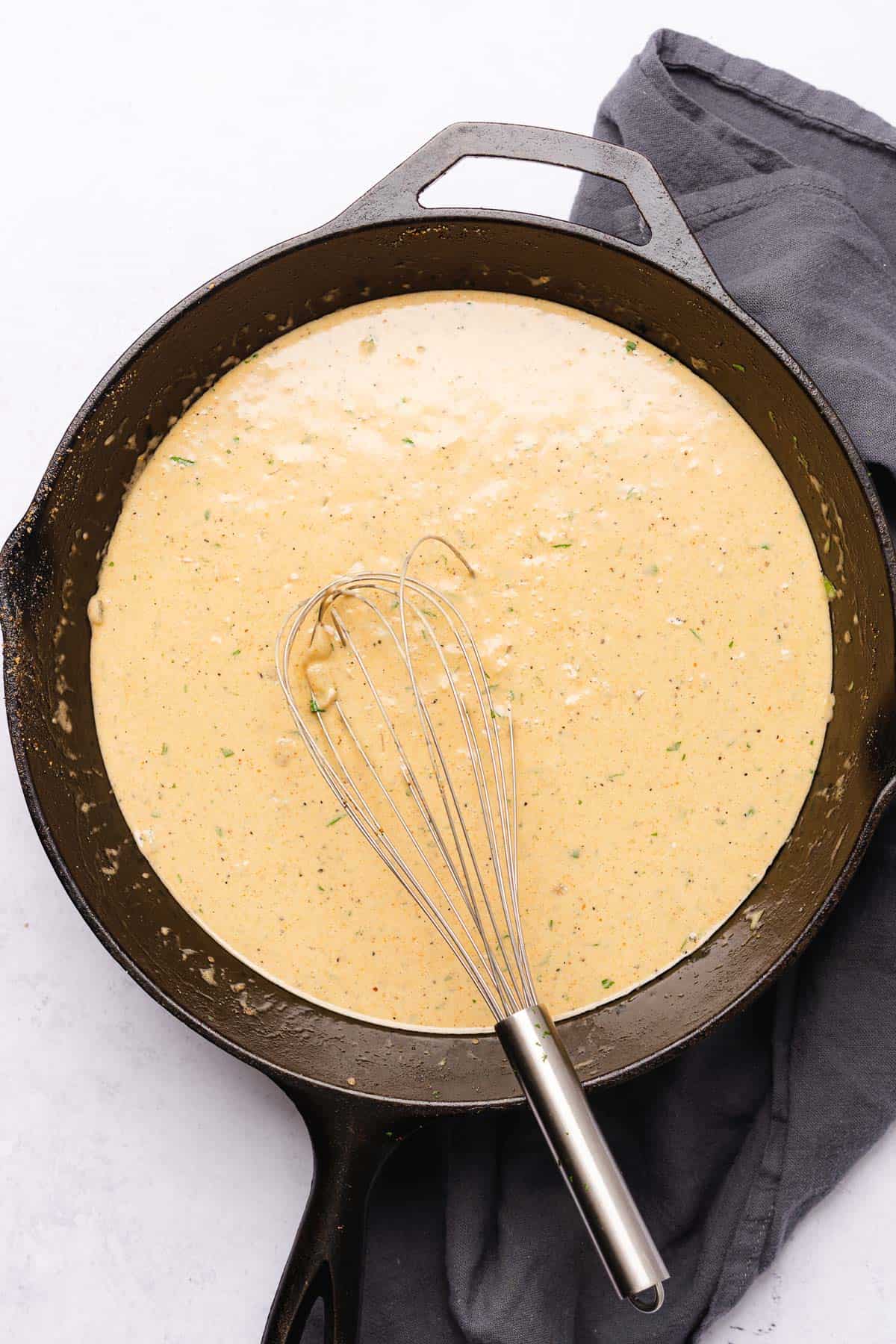 creamy cast iron southern gravy with a whisk