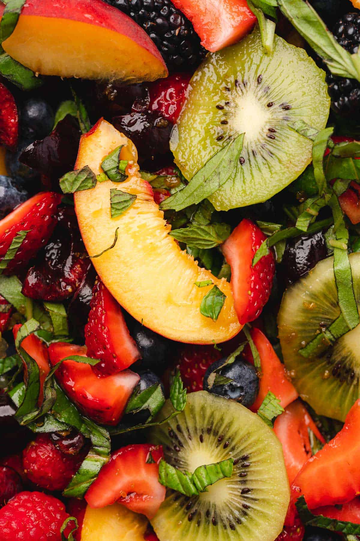 peaches, blueberries, kiwis, strawberries and basil ribbons close up shot