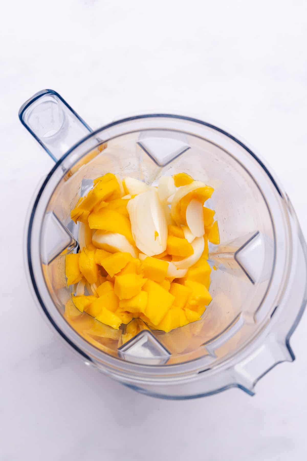 mango and onions in a blender 