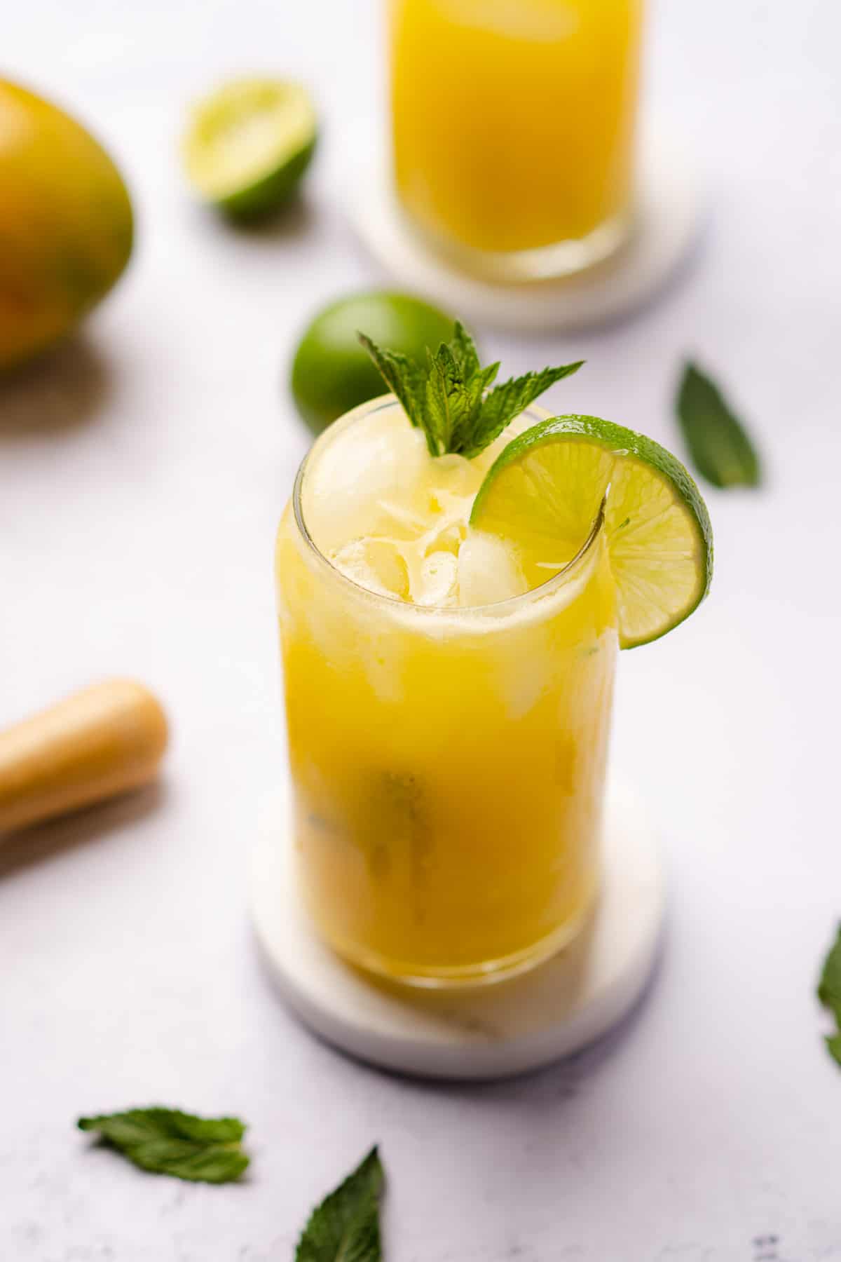 close up shot of pretty mango mojitos with lime and mint