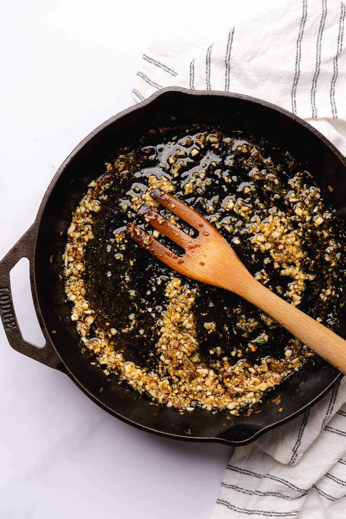 cooking minced garlic in a hot skillet