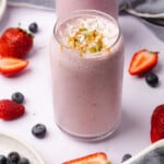 gorgeous keto berry smoothie with fresh berries, coconut flakes, pepitas and peanut butter
