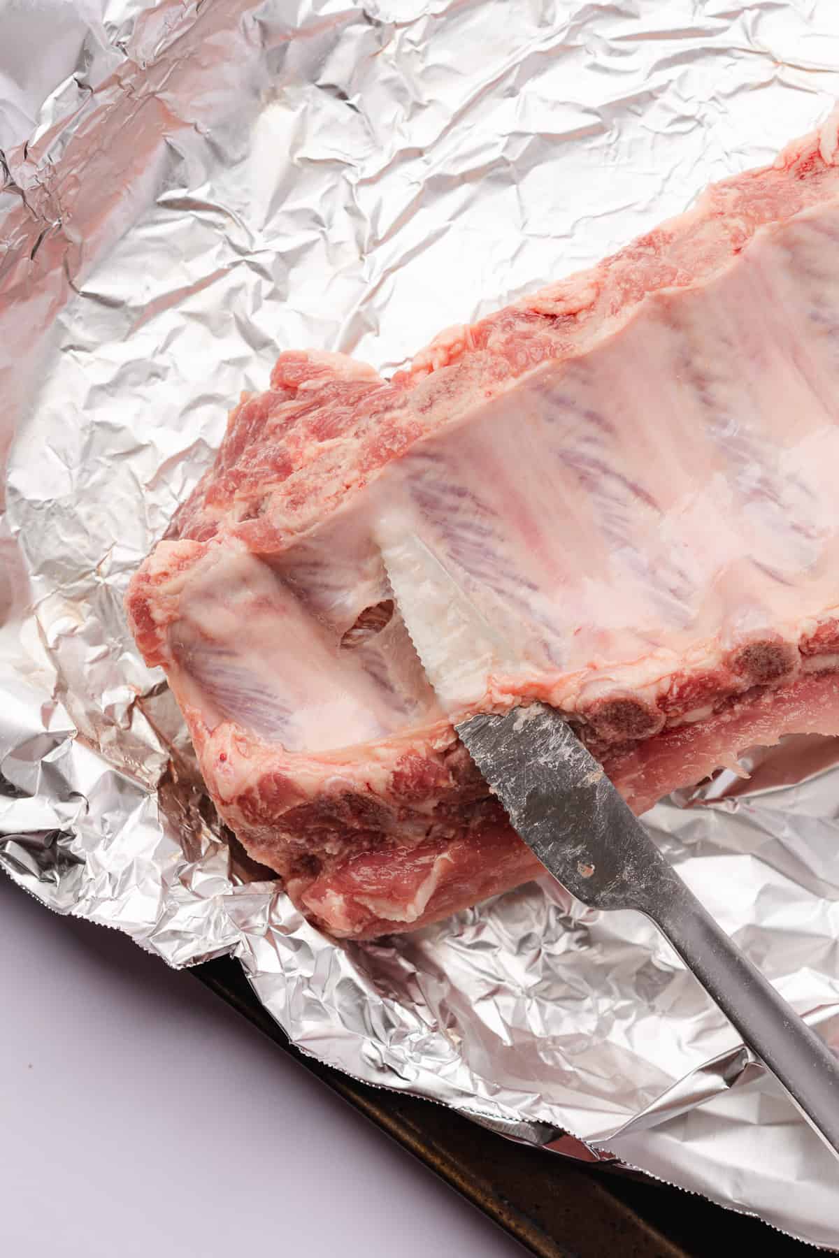 knife under membrane of baby back ribs