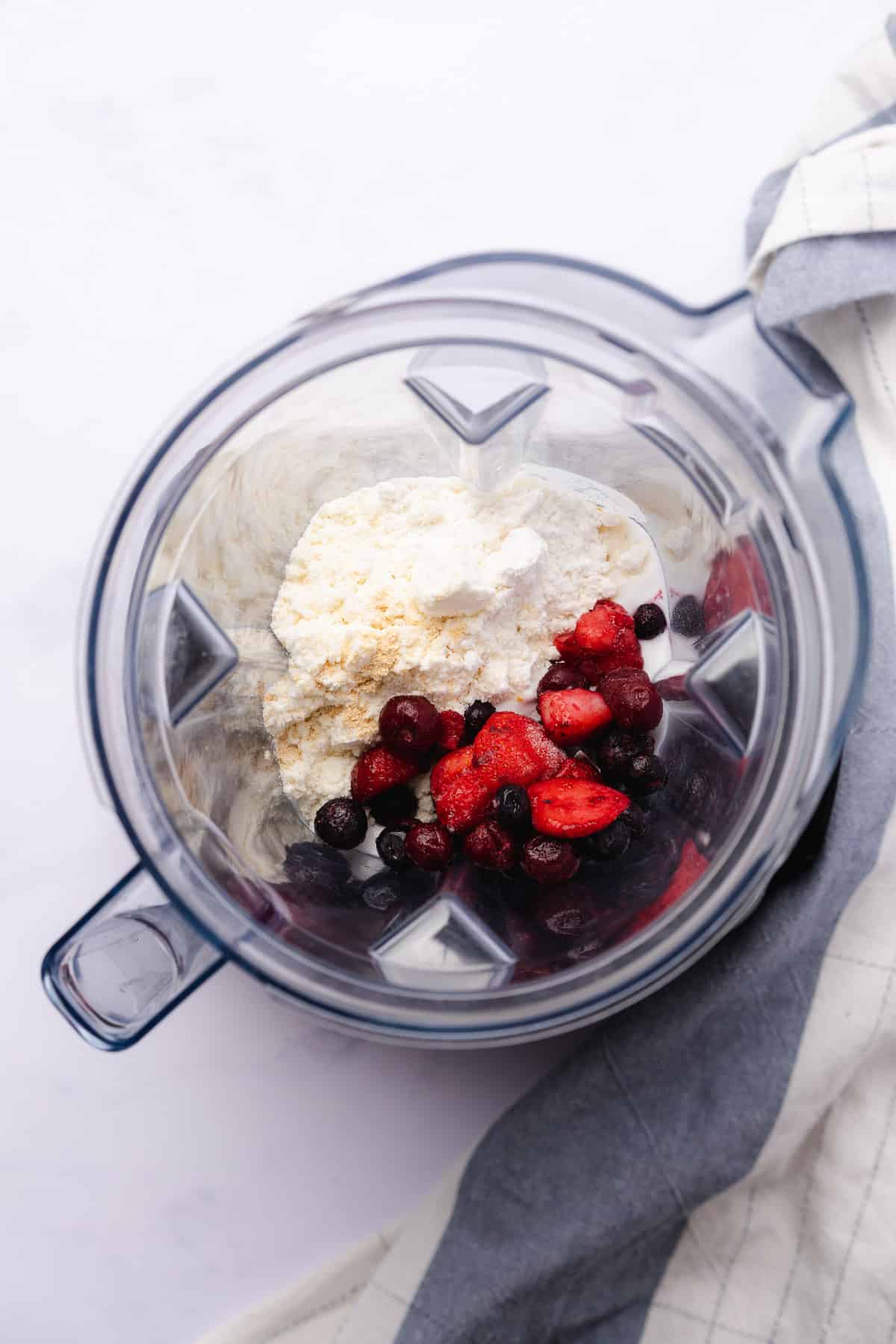 frozen berries added to the blender with lots of additional smoothie ingredients