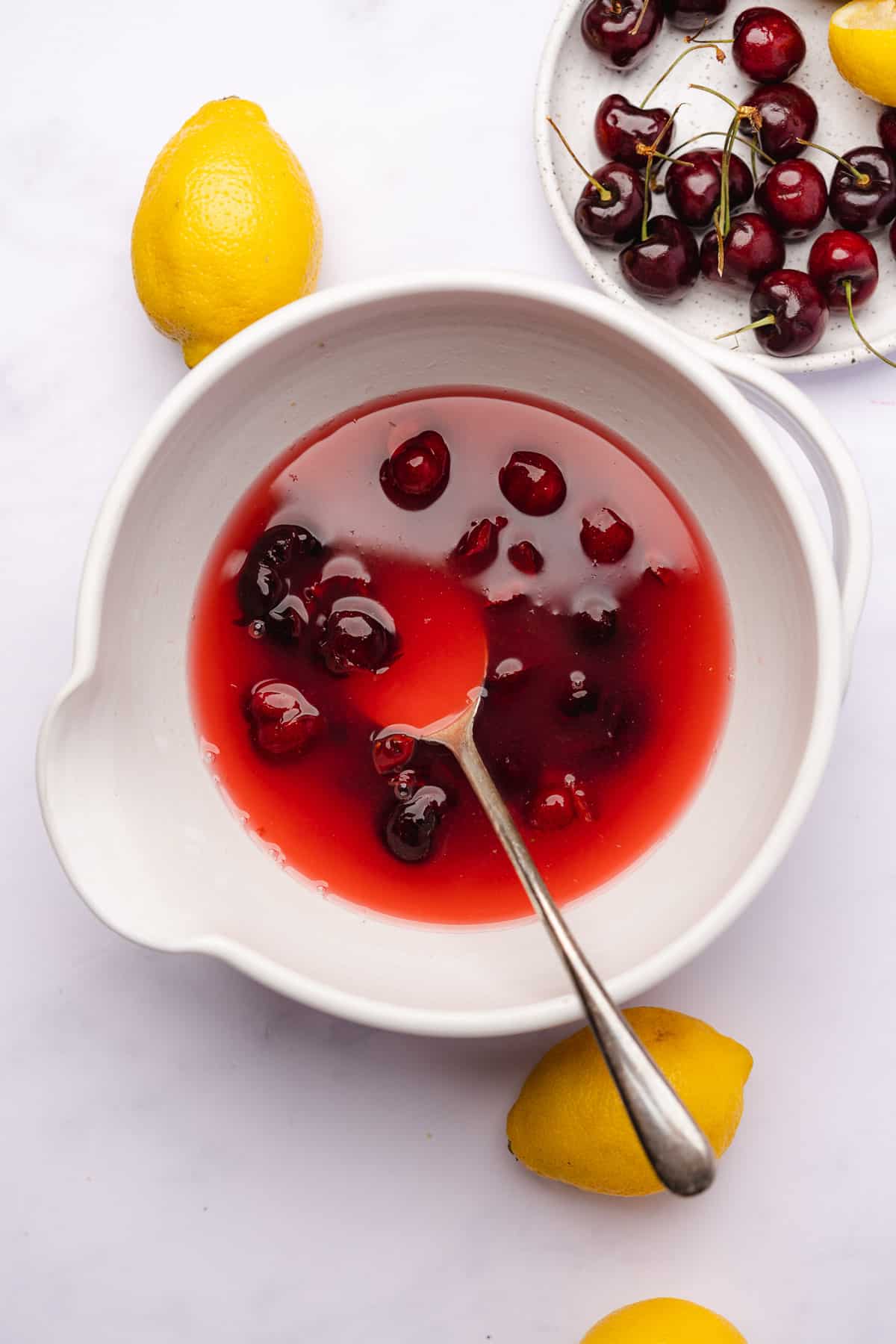 cherry lemonade with bright red liquid in a ceramic bowl