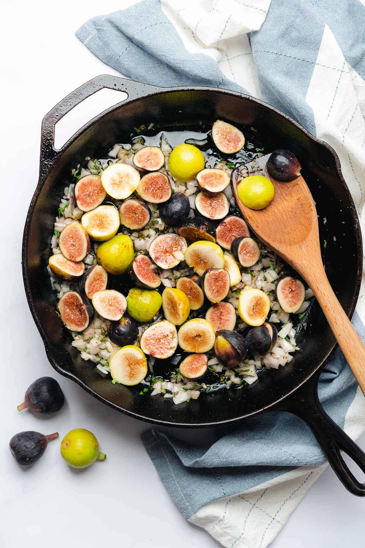 fresh figs in a skillet with shallots and fresh herbs