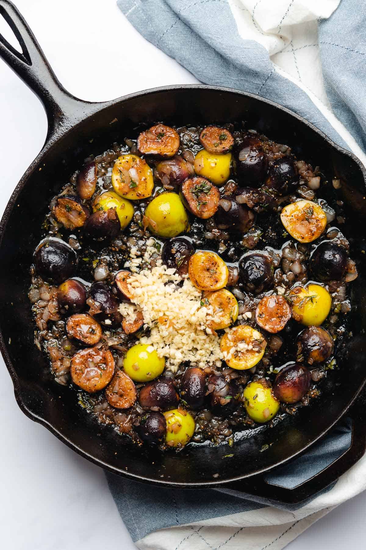 softened figs with garlic in a cast iron skillet 