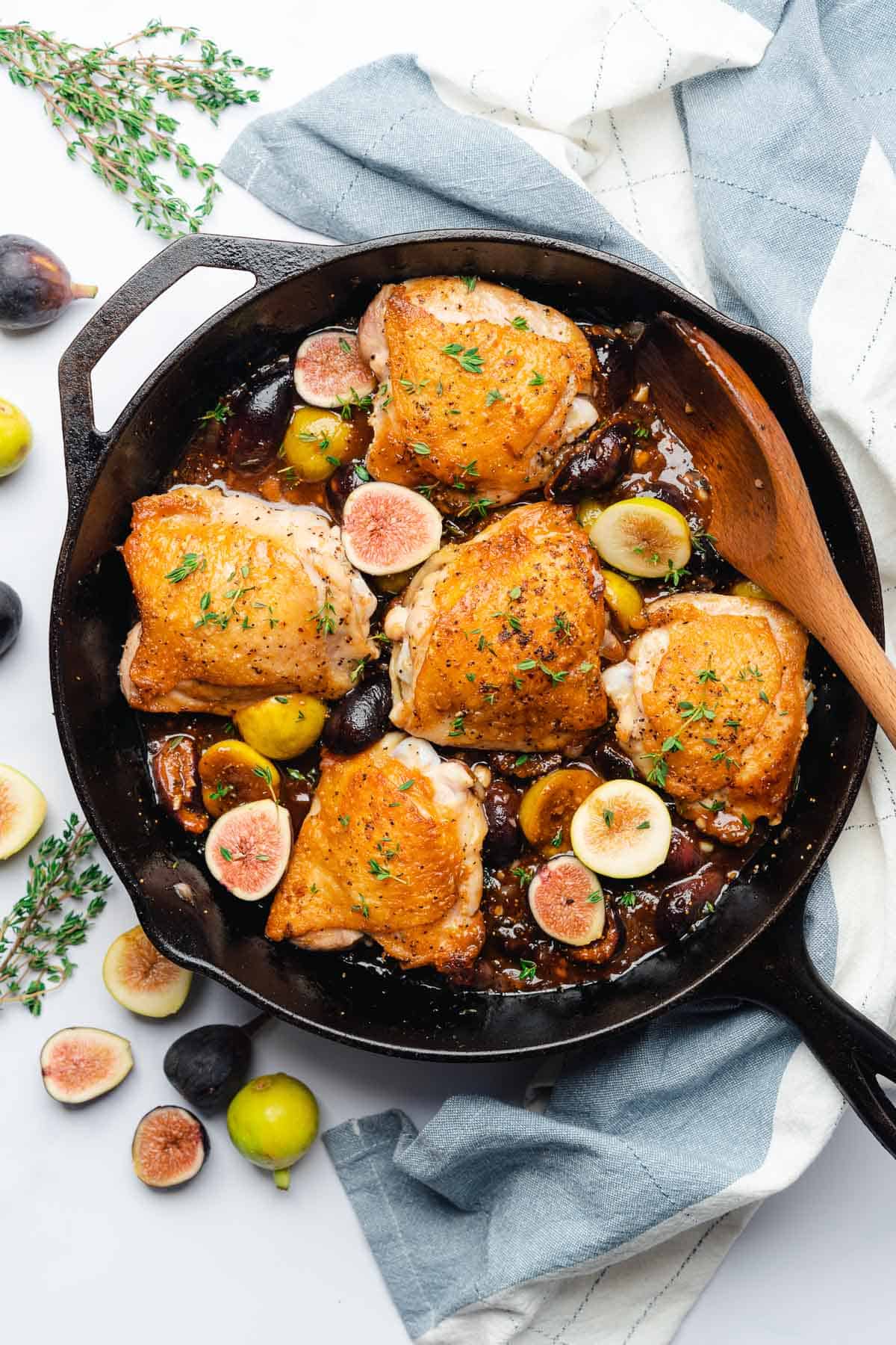 chicken thighs with fresh figs and thyme in a cast iron skillet