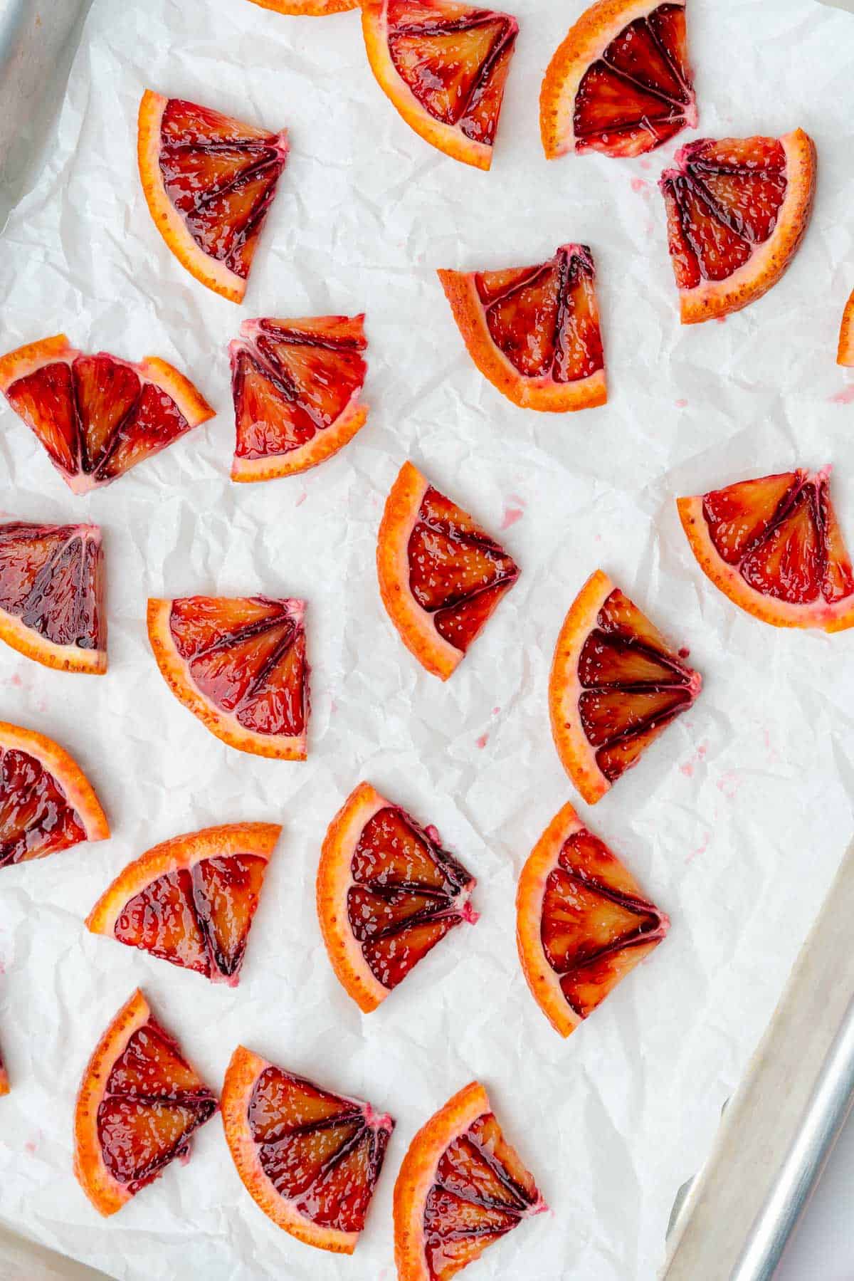 blood orange slices on a baking sheet with white parchment