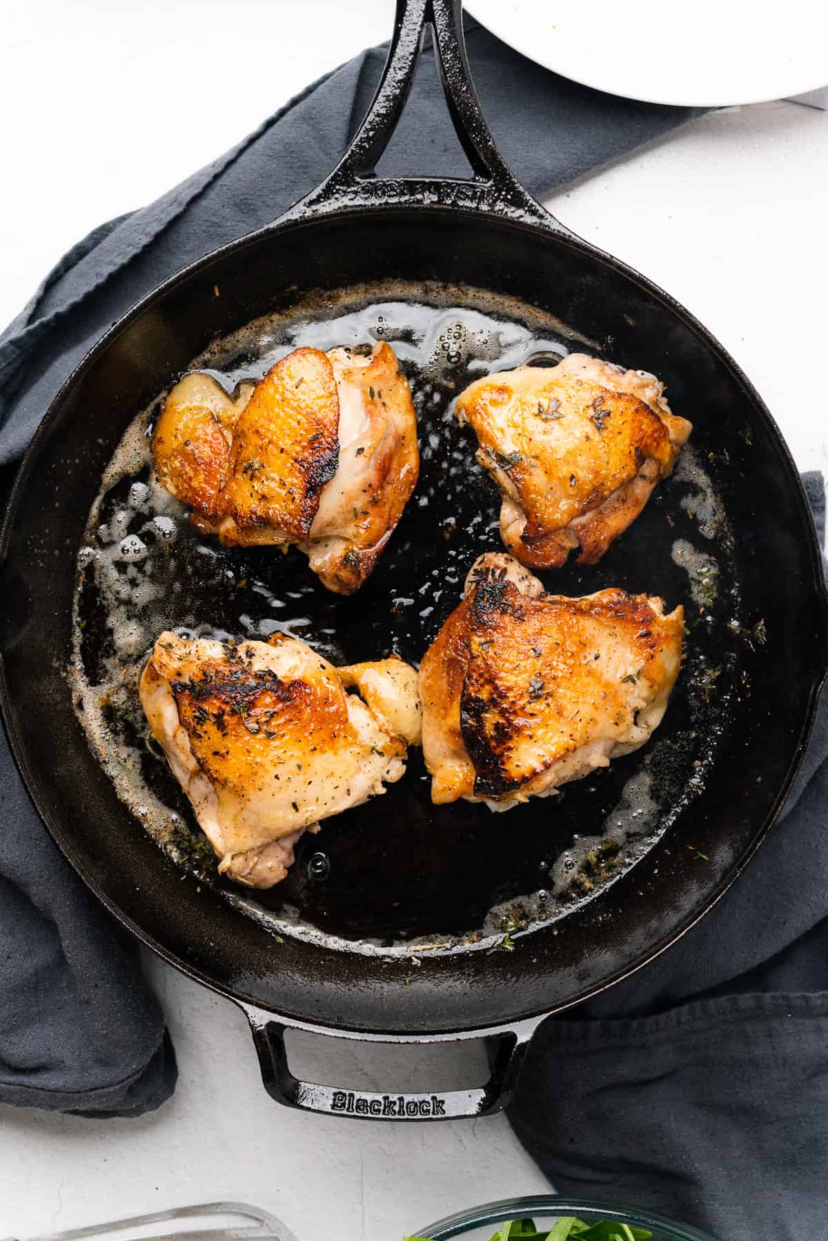 Seared chicken thighs in a cast iron skillet