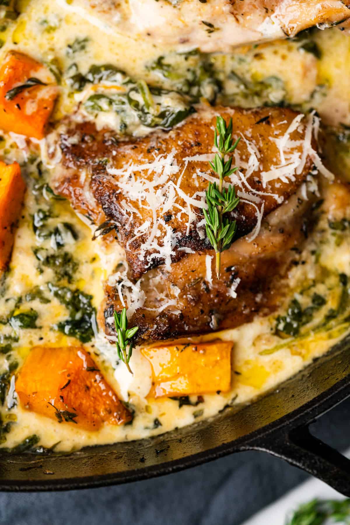 Chicken thighs sitting in butternut and garlic parmesan sauce