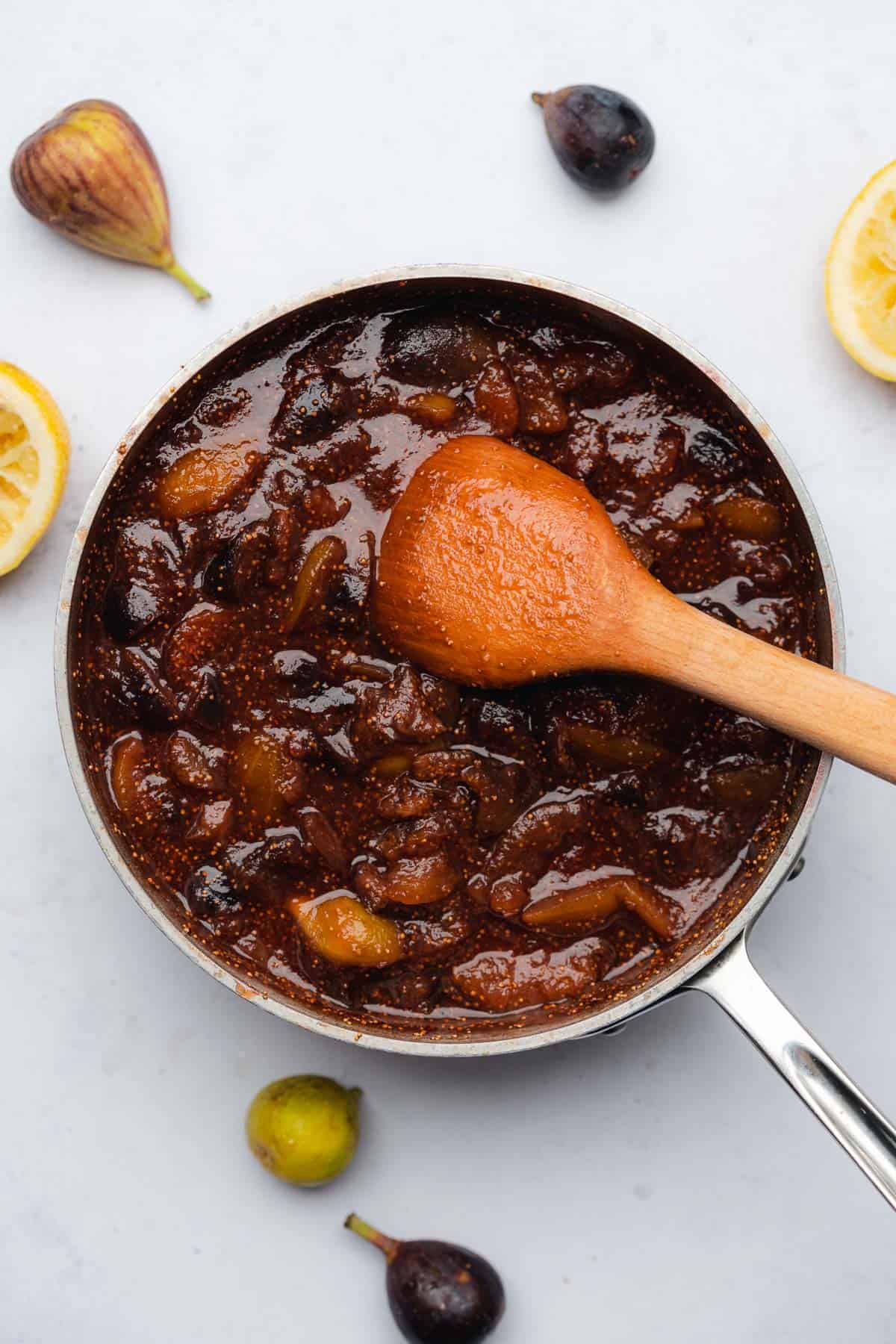 fig spread in a saucepan with water and wooden spoon