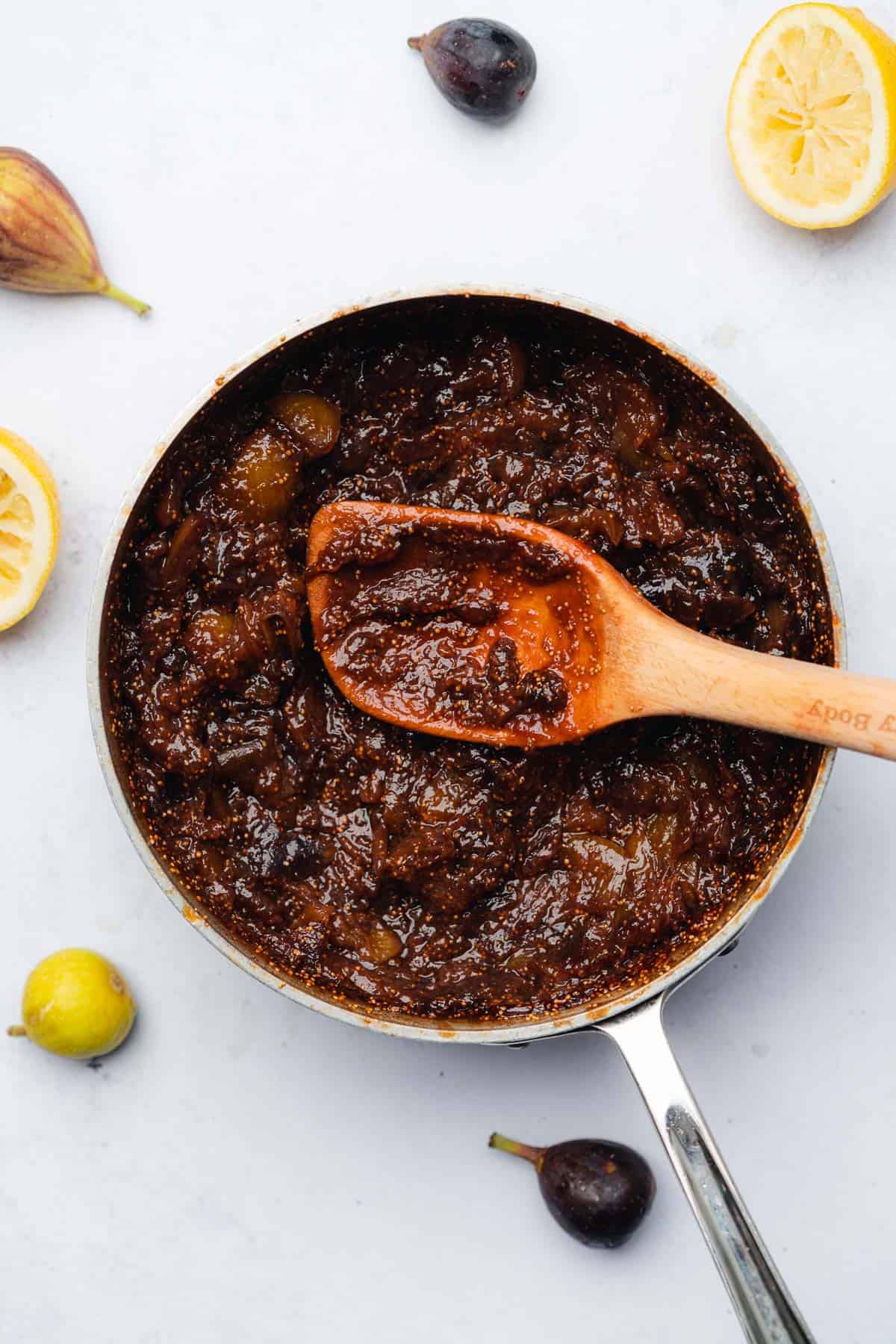 fig spread simmered in saucepan with a wooden spoon